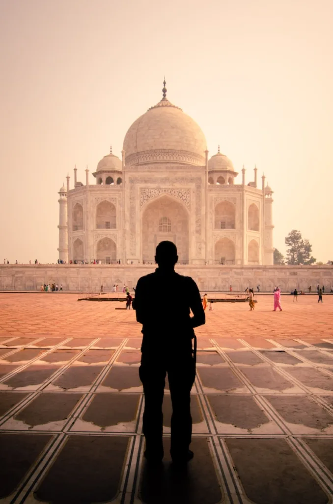 a man standing in front of a white building